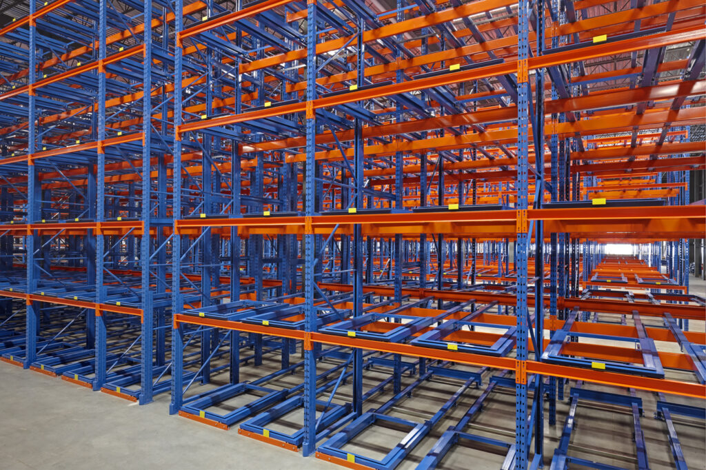 Three-deep back-to-back pushback racking at Mevotech, floor-mounted first level and six levels high, designed for auto parts storage in custom pushback colours.