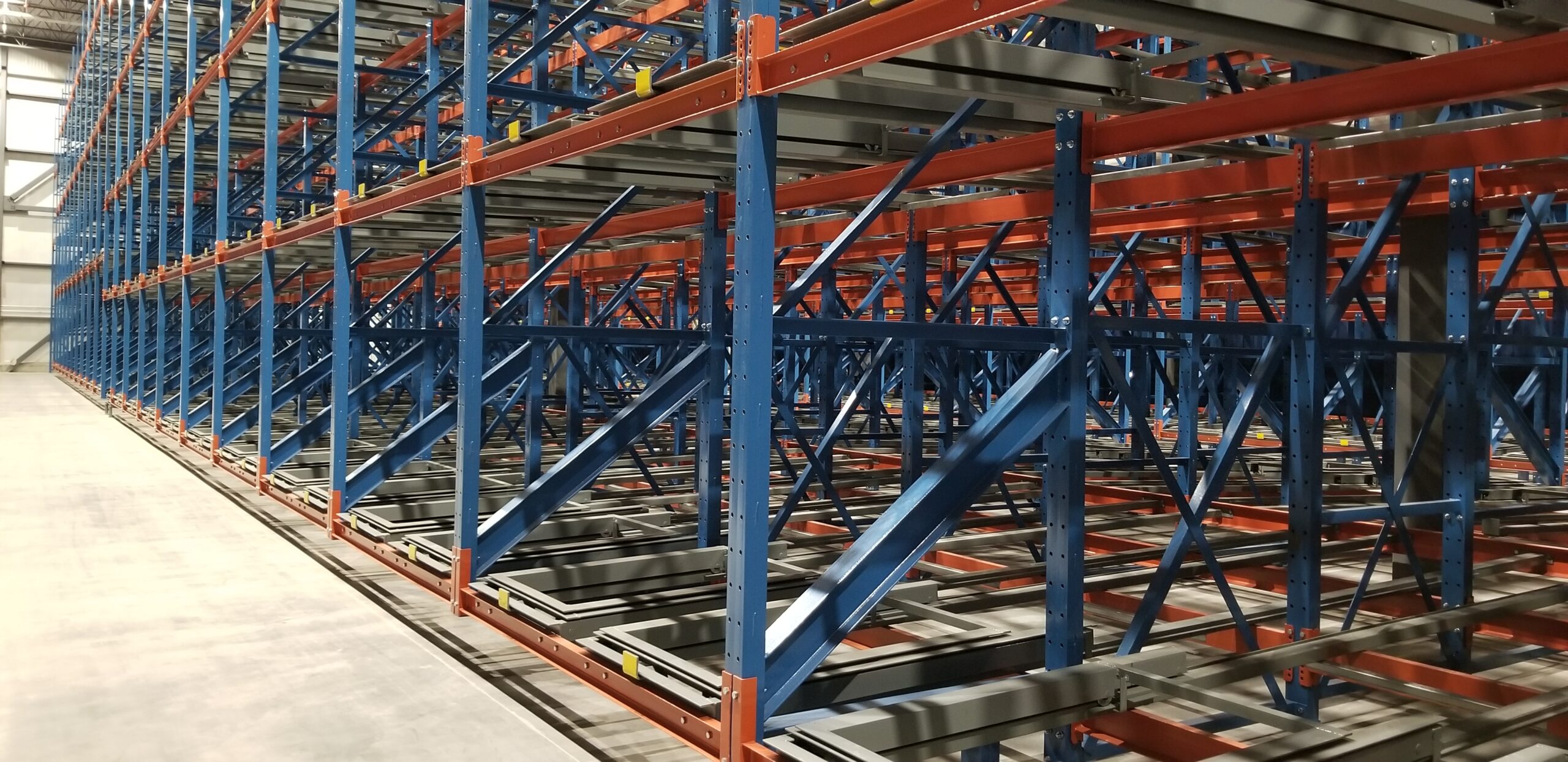 Pushback racking shows in a high density warehouse storage setting