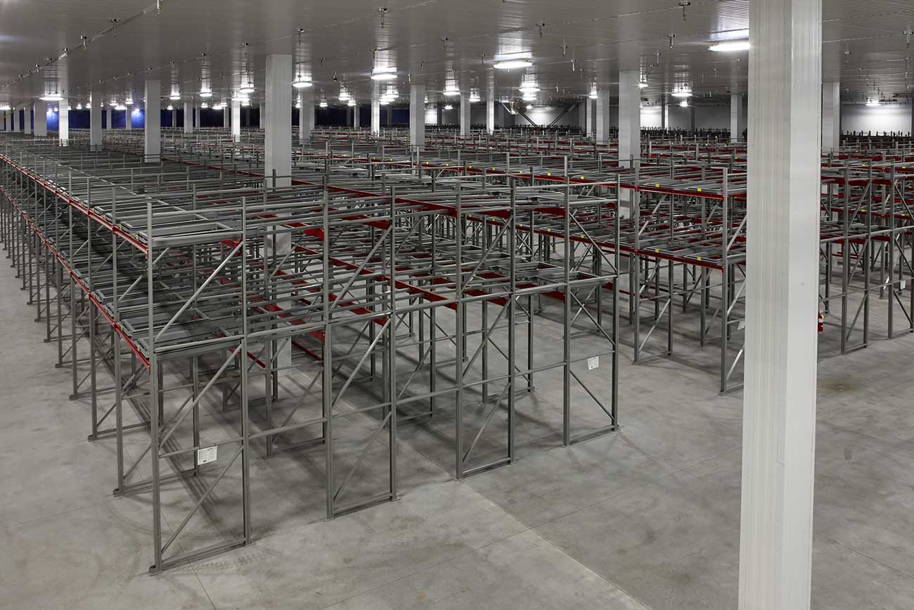 MARS-pet-care-pushback-racking-3 Three-deep back-to-back pushback racking at Mevotech, floor-mounted first level and six levels high, designed for auto parts storage in custom pushback colours.